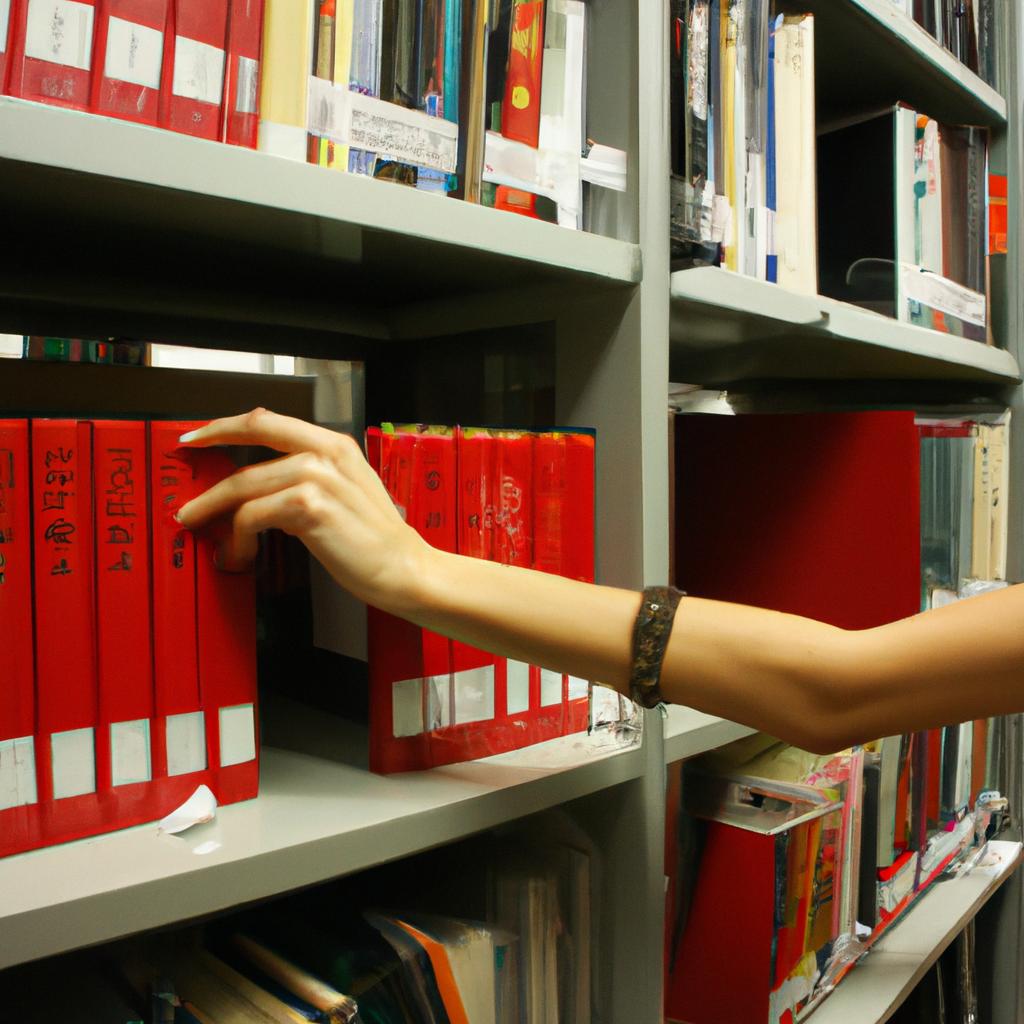Person cataloging books in library